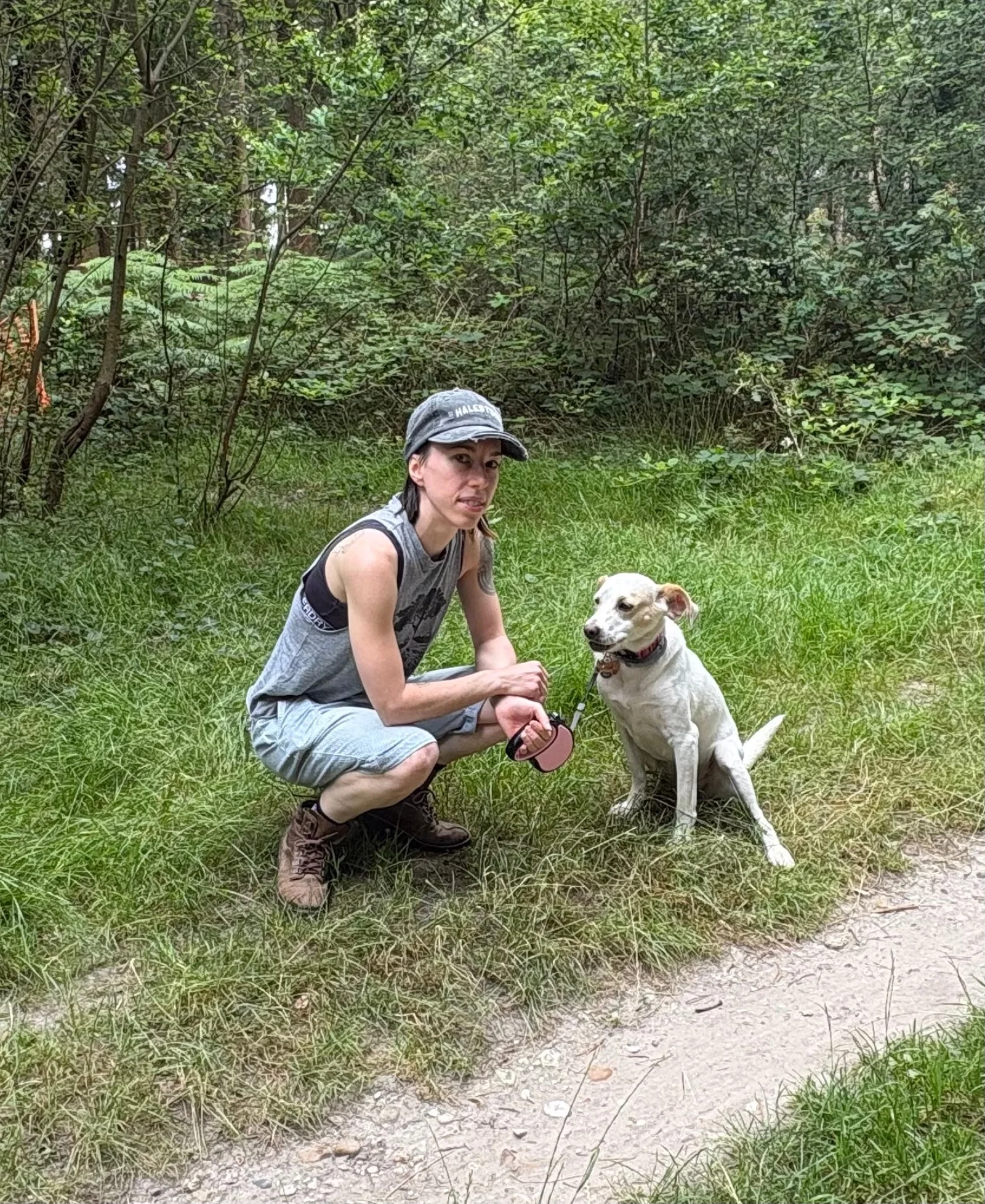 Jo from Paw Treks with a dog during a woodland walk